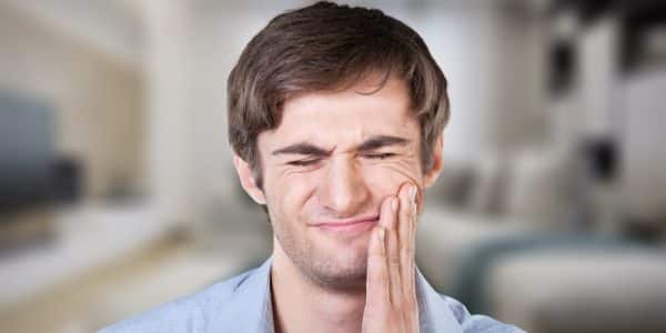 Man experiencing pain from cracked tooth in Sevierville, TN