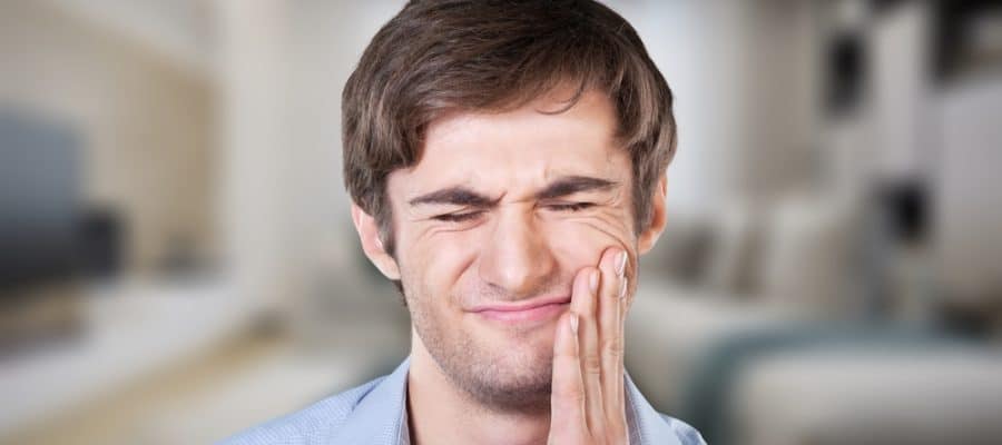 Man experiencing pain from cracked tooth in Sevierville, TN