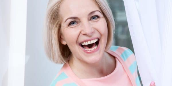 Woman with healthy smile following root canal treatment in Sevierville, TN