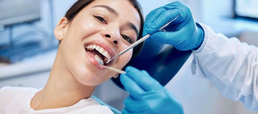 Woman with healthy smile after dental cleaning in Sevierville, TN